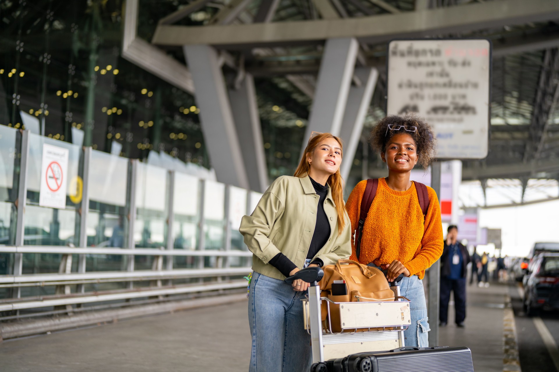 Woman hail a cab at airport terminal.